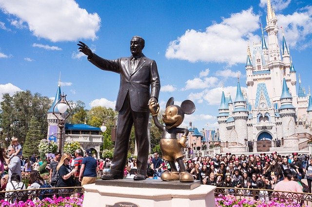 "A budget-friendly Disney trip plan with a magical Disney castle in the background and symbols of savings like a wallet and calculator."